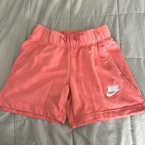 Girls medium Nike shorts. Like new- pinkish/coral color